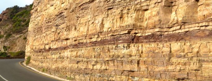 Maroon mudstone beds and buff sandstone beds alongside Chapman’s Peak Drive south of Cape Town.
