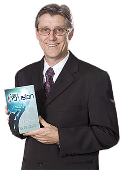 Gary Bates holding his book, Alien Intrusion.